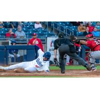 Carson Taylor slides safely into home to score one of the Tulsa Drillers eight runs on Thursday night