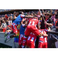 Atlético Ottawa pile on after Zach Verhoven's goal against Pacific FC