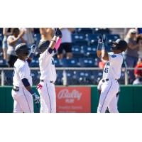 Kyle Lewis of the Everett AquaSox is greeted at home plate by Noelvi Marte and Alberto Rodriguez