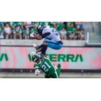 Andrew Harris of the Toronto Argonauts tries to leap the Saskatchewan Roughriders