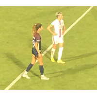 Megan Rapinoe of OL Reign (right) vs. the North Carolina Courage