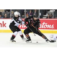 Vancouver Giants centre Ethan Semeniuk (left) vs. the Calgary Hitmen