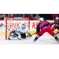 Wichita Thunder goaltender Strauss Mann fends off a shot by the Allen Americans