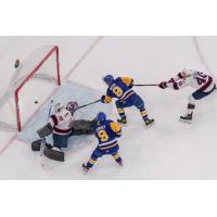 Saskatoon Blades' Brandon Lisowsky and Jayden Wiens battle Drew Sim and Parker Berge of the Regina Pats