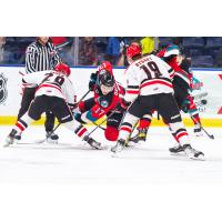 Kelowna Rockets' Colton Dach battles Brayden Yager and Martin Rysavy of the Moose Jaw Warriors