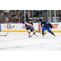 Rapid City Rush defenseman Simon Lavigne (center)