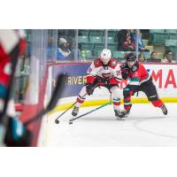 Prince George Cougars' Blake Eastman battles Kelowna Rockets' Will Munro