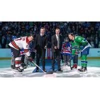 Tucson Roadrunners' Adam Cracknell and Abbotsford Canucks' Chase Wouters with Vancouver Canucks legends Daniel and Henrik Sedin