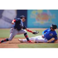 Isaac Collins of the Biloxi Shuckers tries to avoid the tag from the Mississippi Braves