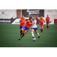 Detroit City FC's Kenna White battles Flint City AFC's Alana Wood