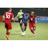 El Paso Locomotive FC's Aaron Gómez battles Phoenix Rising FC's Carlos Harvey